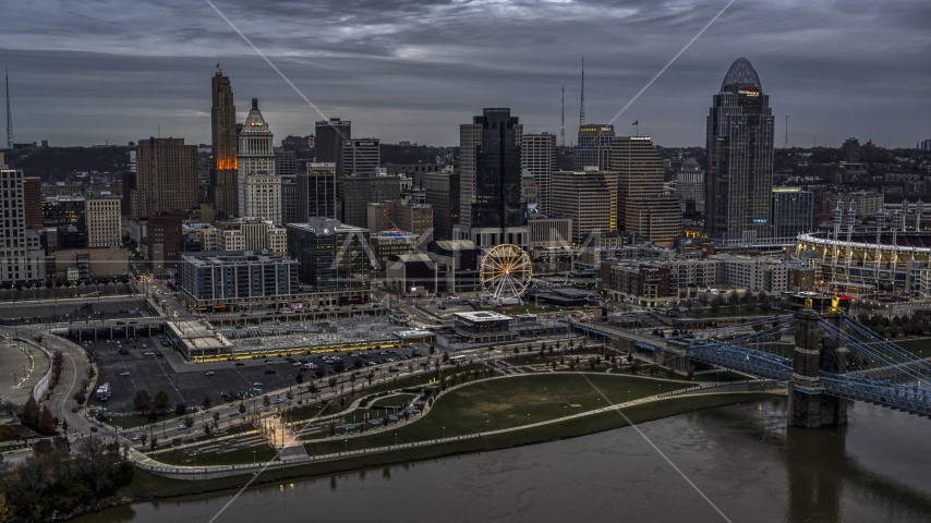 The city's downtown skyline and Ferris wheel at sunset from Ohio River, Downtown Cincinnati, Ohio Aerial Stock Photo DXP001_097_0011 | Axiom Images