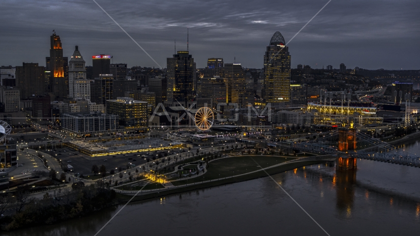 The city skyline and bridge lit for twilight, seen from Ohio River, Downtown Cincinnati, Ohio Aerial Stock Photo DXP001_098_0001 | Axiom Images
