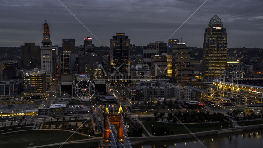 City skyline and the end of the bridge lit for twilight, Downtown Cincinnati, Ohio Aerial Stock Photo DXP001_098_0002 | Axiom Images