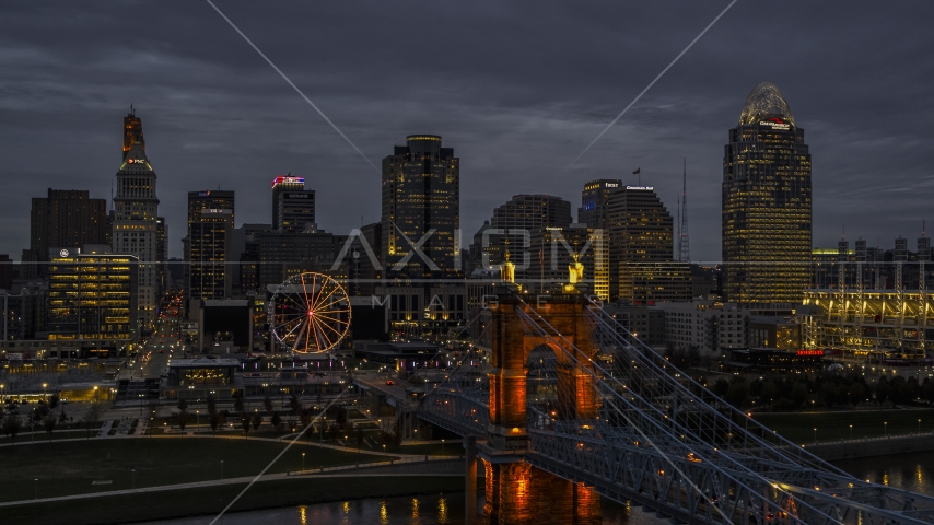 Roebling Bridge and city skyline lit up at twilight, Downtown Cincinnati, Ohio Aerial Stock Photo DXP001_098_0005 | Axiom Images