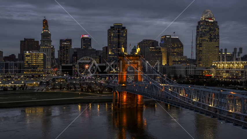 A view of the bridge and city skyline at twilight from the river, Downtown Cincinnati, Ohio Aerial Stock Photo DXP001_098_0006 | Axiom Images