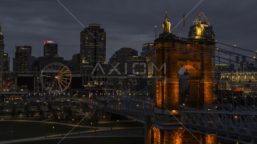 City skyline, Ferris wheel and Roebling Bridge lit up at twilight, Downtown Cincinnati, Ohio Aerial Stock Photo DXP001_098_0008 | Axiom Images