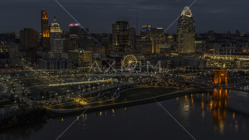 Ferris wheel and skyscrapers at twilight seen from the river, Downtown Cincinnati, Ohio Aerial Stock Photo DXP001_098_0014 | Axiom Images