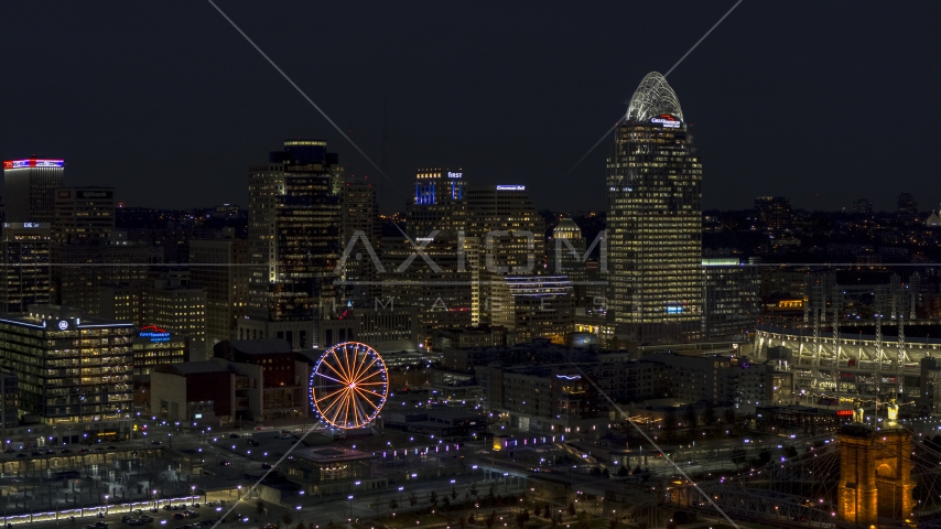 A view of the city skyline and Ferris wheel at night, Downtown Cincinnati, Ohio Aerial Stock Photo DXP001_098_0020 | Axiom Images