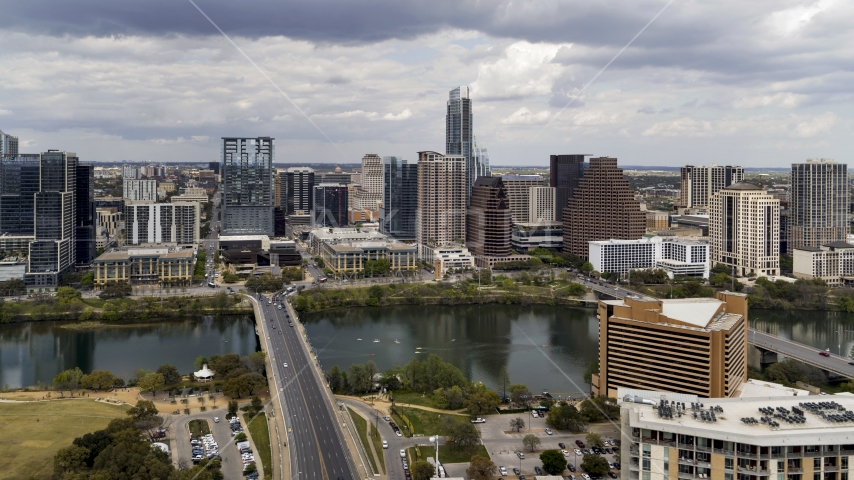 The First Street Bridge spanning Lady Bird Lake, looking toward the skyline, Downtown Austin, Texas Aerial Stock Photo DXP002_102_0008 | Axiom Images