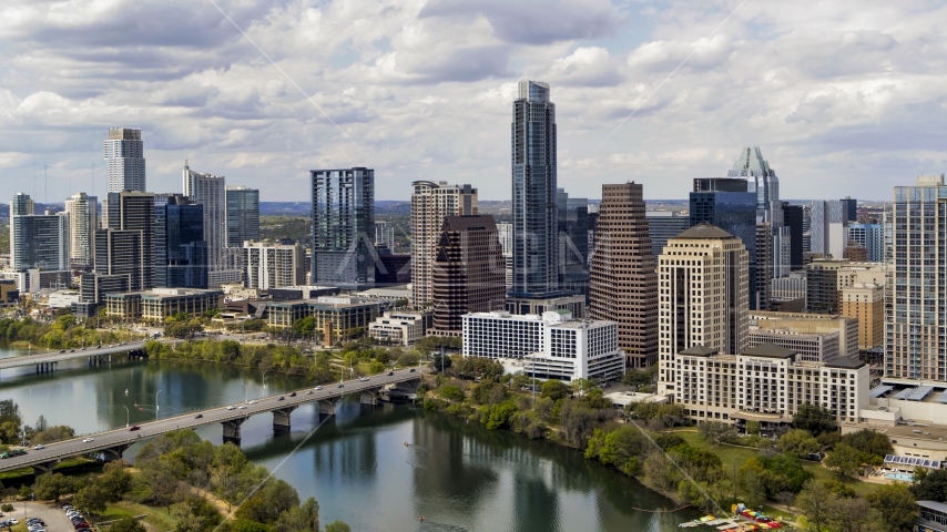 Tall skyscrapers in the city skyline by bridges and Lady Bird Lake, Downtown Austin, Texas Aerial Stock Photo DXP002_102_0021 | Axiom Images