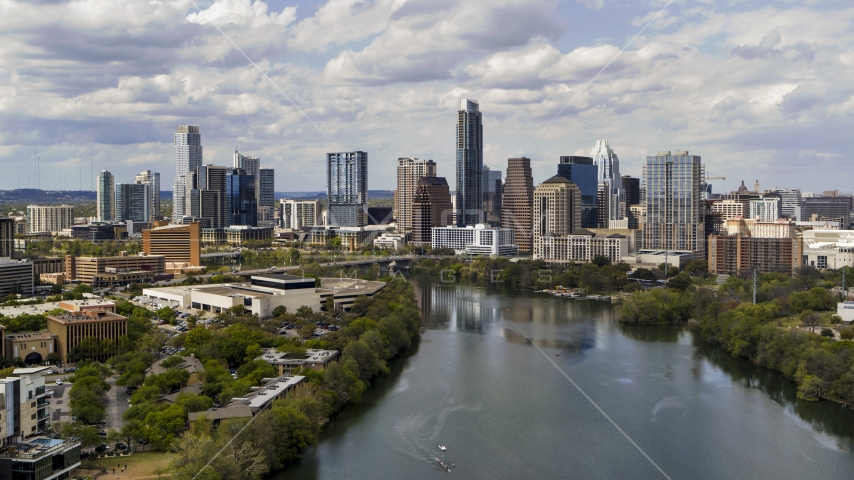 A view of the city skyline while flying over Lady Bird Lake, Downtown Austin, Texas Aerial Stock Photo DXP002_102_0023 | Axiom Images