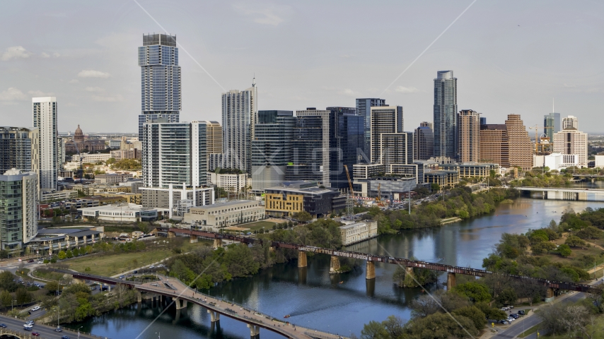 Towering city skyscrapers, and bridges spanning Lady Bird Lake, Downtown Austin, Texas Aerial Stock Photo DXP002_104_0002 | Axiom Images