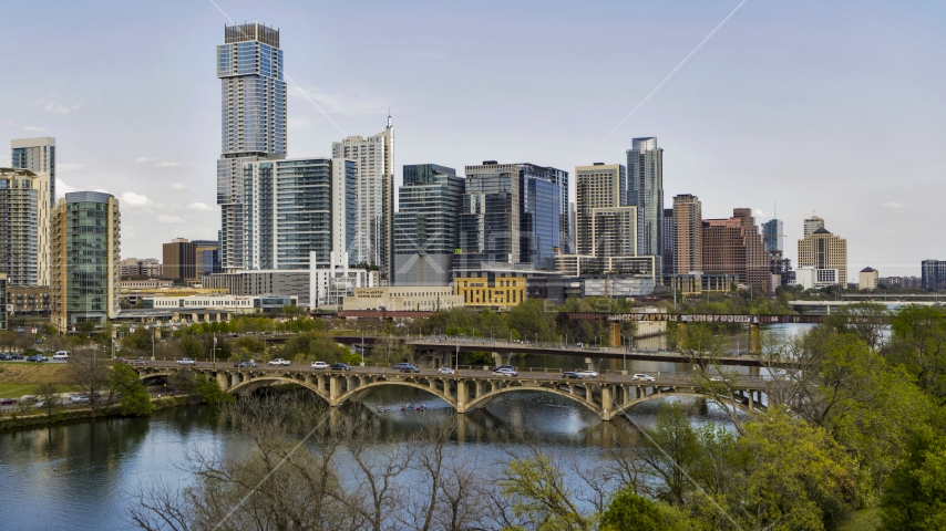 Bridges over Lady Bird Lake near waterfront skyscrapers, Downtown Austin, Texas Aerial Stock Photo DXP002_104_0005 | Axiom Images