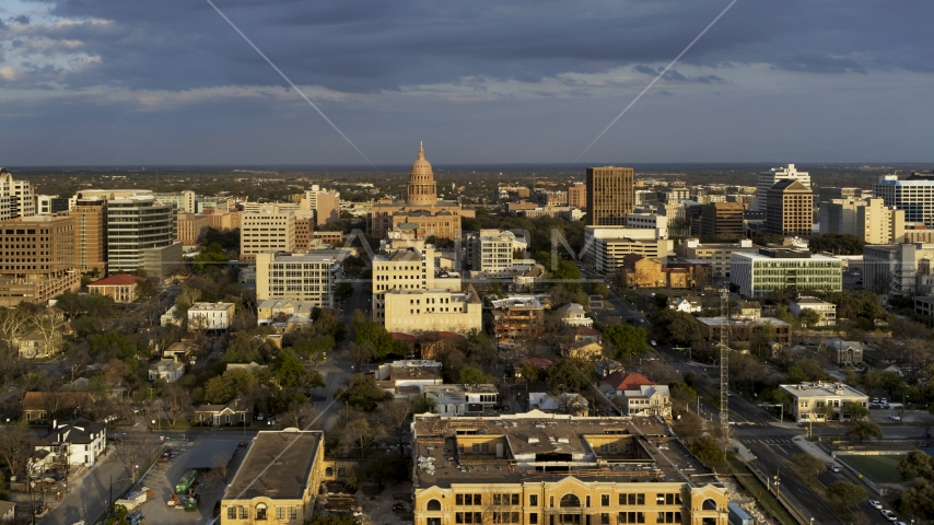 The Texas State Capitol dome and office buildings at sunset before descent in Downtown Austin, Texas Aerial Stock Photo DXP002_105_0005 | Axiom Images