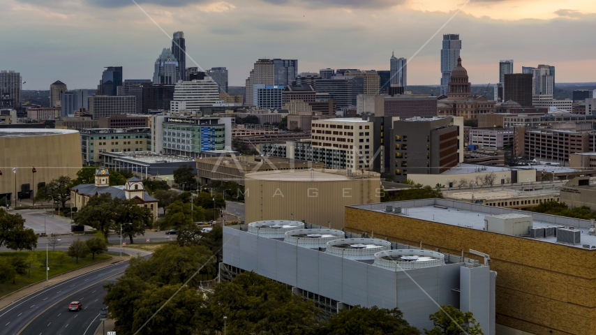 A view of hospital, skyscrapers and capitol dome at sunset in Downtown Austin, Texas Aerial Stock Photo DXP002_105_0009 | Axiom Images