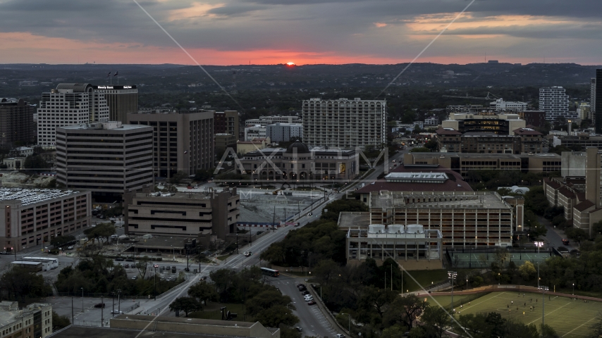 The setting sun behind university campus, Austin, Texas Aerial Stock Photo DXP002_105_0017 | Axiom Images
