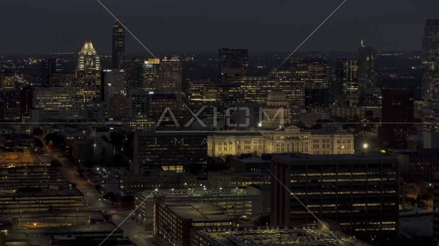 Office buildings, skyscrapers and capitol at night in Downtown Austin, Texas Aerial Stock Photo DXP002_106_0001 | Axiom Images