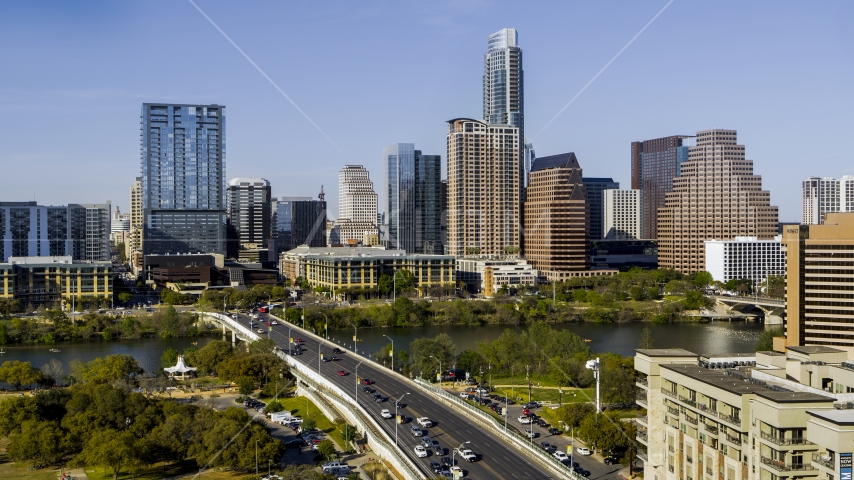 The city's skyline across Lady Bird Lake seen from bridge, Downtown Austin, Texas Aerial Stock Photo DXP002_109_0001 | Axiom Images