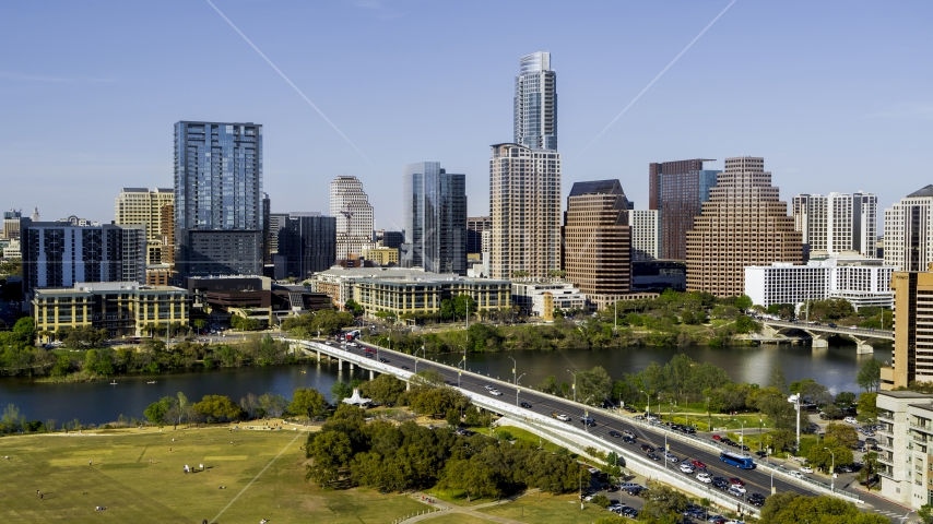 A view of the city's skyline across Lady Bird Lake seen from a bridge, Downtown Austin, Texas Aerial Stock Photo DXP002_109_0002 | Axiom Images