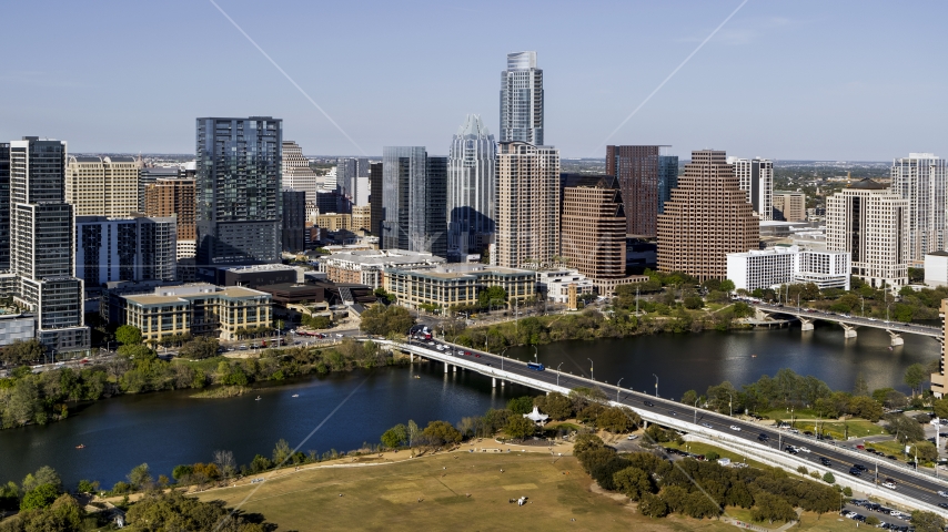 The city's skyline across Lady Bird Lake, seen from park near bridge, Downtown Austin, Texas Aerial Stock Photo DXP002_109_0003 | Axiom Images