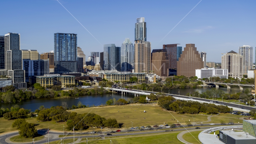 The city's skyline on the opposite side of Lady Bird Lake seen from a street near bridge, Downtown Austin, Texas Aerial Stock Photo DXP002_109_0005 | Axiom Images
