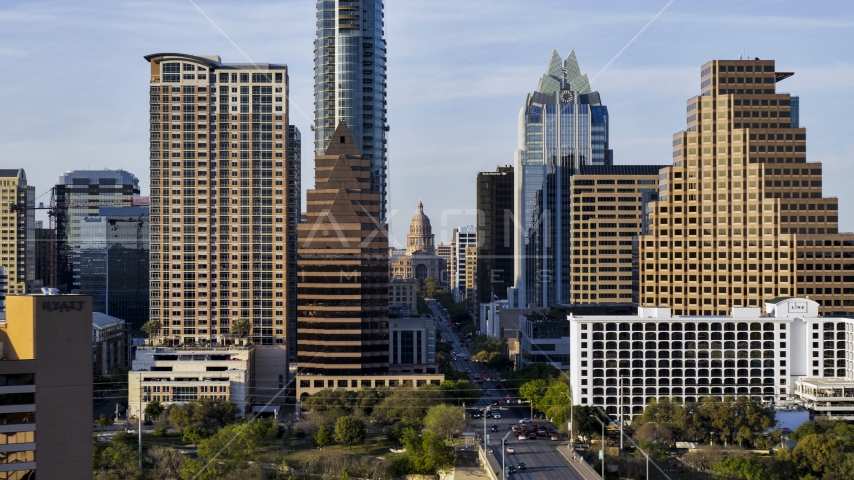 The state capitol building seen between skyscrapers in Downtown Austin, Texas Aerial Stock Photo DXP002_109_0017 | Axiom Images