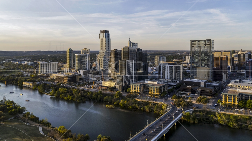 A view of the city's waterfront skyline and Lady Bird Lake at sunset in Downtown Austin, Texas Aerial Stock Photo DXP002_110_0001 | Axiom Images