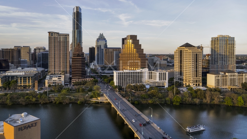 Waterfront skyscrapers across Lady Bird Lake at sunset in Downtown Austin, Texas Aerial Stock Photo DXP002_110_0003 | Axiom Images