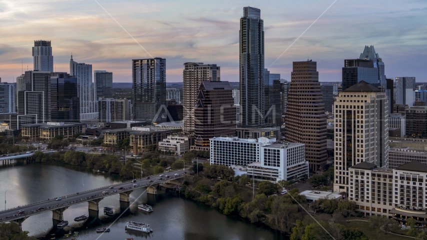 The Austonian in city skyline by Lady Bird Lake at twilight in Downtown Austin, Texas Aerial Stock Photo DXP002_110_0008 | Axiom Images