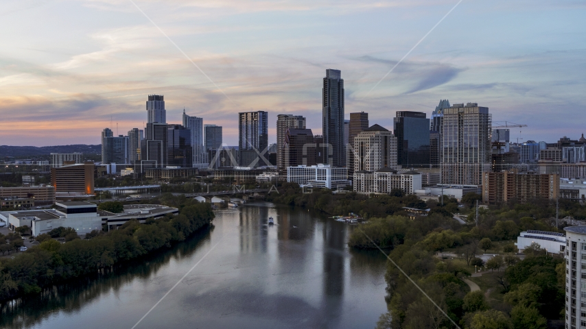The city waterfront skyline by Lady Bird Lake at twilight in Downtown Austin, Texas Aerial Stock Photo DXP002_110_0010 | Axiom Images
