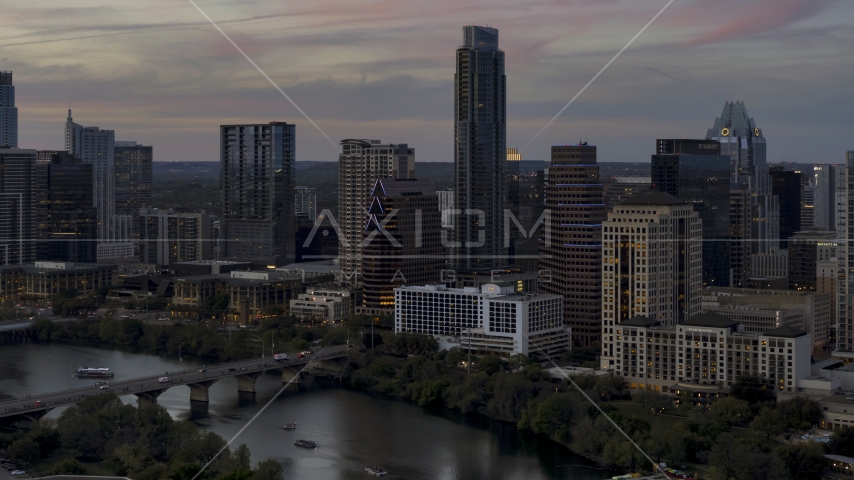 Bridge and skyscrapers by Lady Bird Lake at twilight in Downtown Austin, Texas Aerial Stock Photo DXP002_110_0014 | Axiom Images