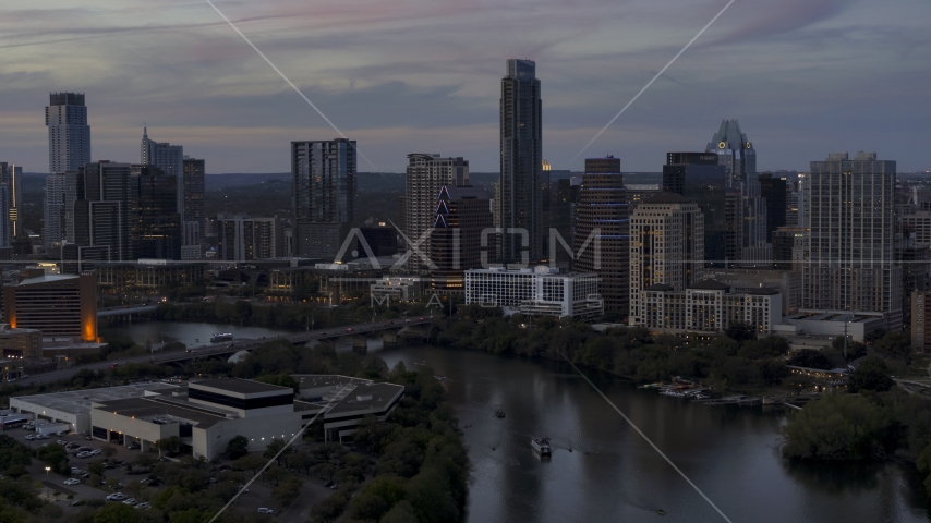 The skyline by Lady Bird Lake and bridge at twilight in Downtown Austin, Texas Aerial Stock Photo DXP002_110_0015 | Axiom Images