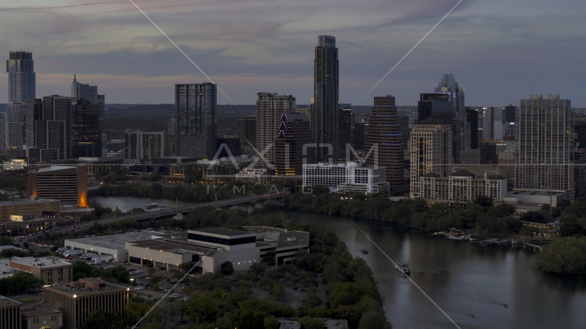 Focus on skyline by Lady Bird Lake and bridge at twilight in Downtown Austin, Texas Aerial Stock Photo DXP002_110_0016 | Axiom Images