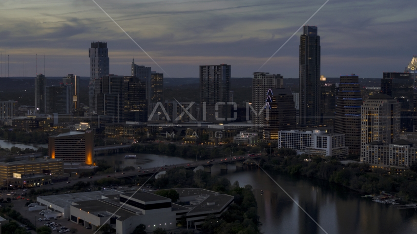 Aerial stock photo of the waterfront skyline by Lady Bird Lake and bridge at twilight in Downtown Austin, Texas Aerial Stock Photo DXP002_110_0018 | Axiom Images