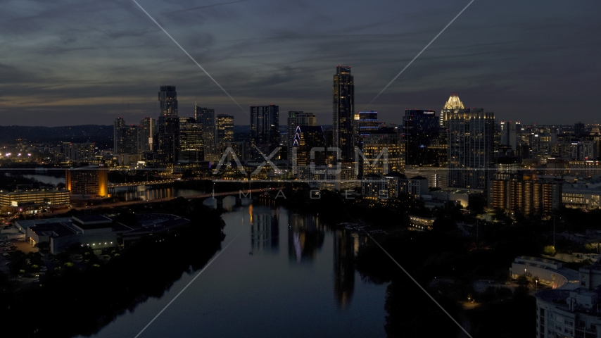 The waterfront skyline on the shore of Lady Bird Lake at twilight in Downtown Austin, Texas Aerial Stock Photo DXP002_111_0003 | Axiom Images