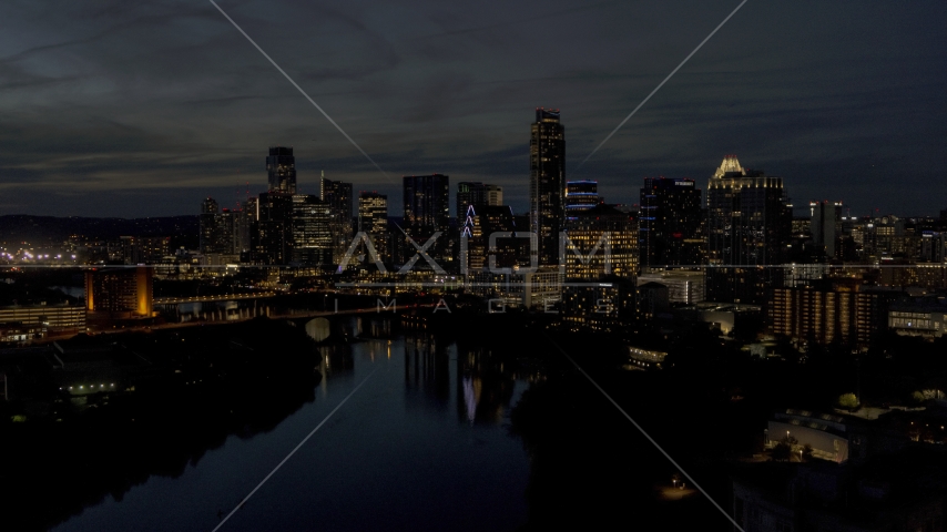 A waterfront skyline on the shore of Lady Bird Lake at twilight in Downtown Austin, Texas Aerial Stock Photo DXP002_111_0004 | Axiom Images