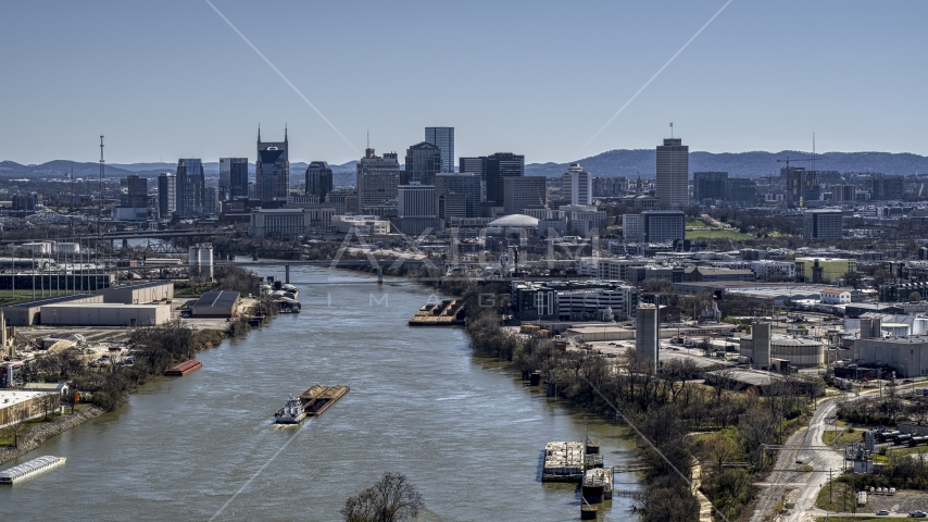 A barge sailing the river toward the city's skyline, Downtown Nashville, Tennessee Aerial Stock Photo DXP002_112_0008 | Axiom Images