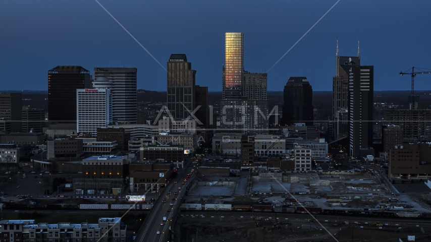 Light reflecting off skyscrapers in city's skyline, seen from Church Street at twilight in Downtown Nashville, Tennessee Aerial Stock Photo DXP002_115_0002 | Axiom Images