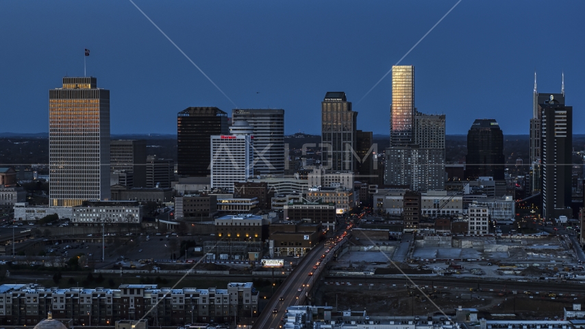 A view of light reflecting off skyscrapers in city's skyline, seen from near Church Street at twilight in Downtown Nashville, Tennessee Aerial Stock Photo DXP002_115_0005 | Axiom Images