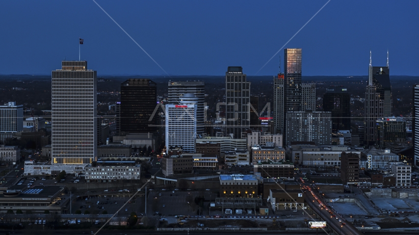 A view of skyscrapers reflecting light in the city skyline at twilight in Downtown Nashville, Tennessee Aerial Stock Photo DXP002_115_0006 | Axiom Images