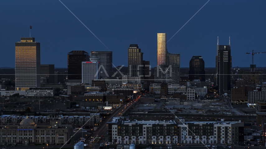 Towering skyscrapers reflecting light in the city skyline at twilight before descent, Downtown Nashville, Tennessee Aerial Stock Photo DXP002_115_0008 | Axiom Images