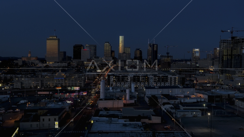 A wide view of skyscrapers reflecting light in the city skyline at twilight in Downtown Nashville, Tennessee Aerial Stock Photo DXP002_115_0009 | Axiom Images