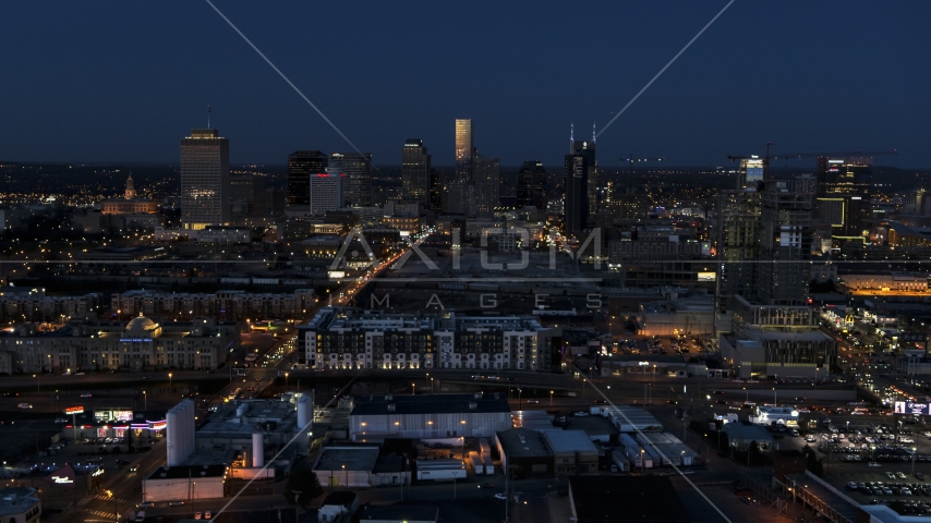 A wide view of the city skyline, high-rise under construction at twilight, Downtown Nashville, Tennessee Aerial Stock Photo DXP002_115_0010 | Axiom Images