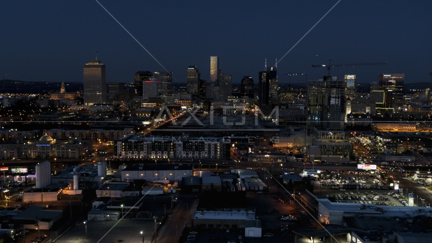 A wide view of city skyline at twilight, near high-rise construction, Downtown Nashville, Tennessee Aerial Stock Photo DXP002_115_0012 | Axiom Images