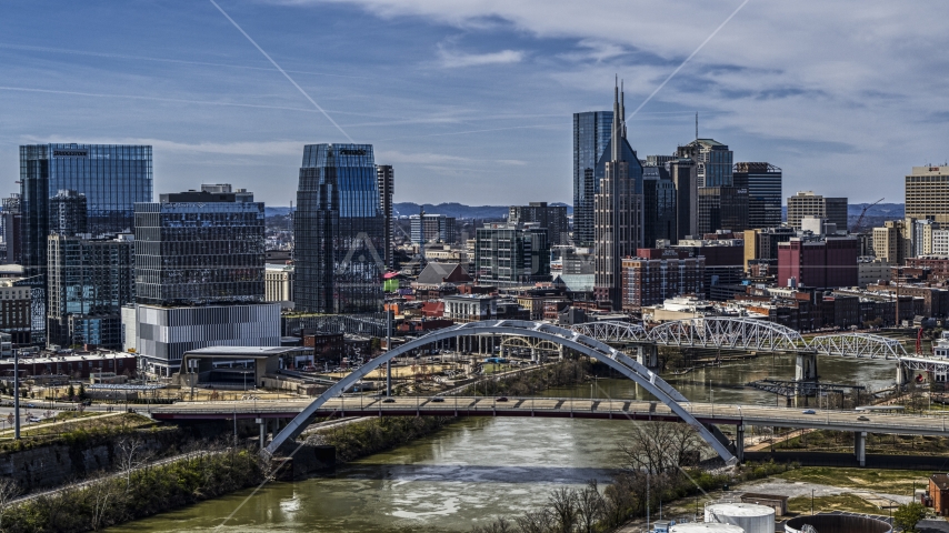 A bridge, and skyscrapers near the Cumberland River in Downtown Nashville, Tennessee Aerial Stock Photo DXP002_116_0012 | Axiom Images