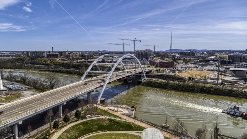 A barge sailing away from a bridge in Nashville, Tennessee Aerial Stock Photo DXP002_117_0003 | Axiom Images