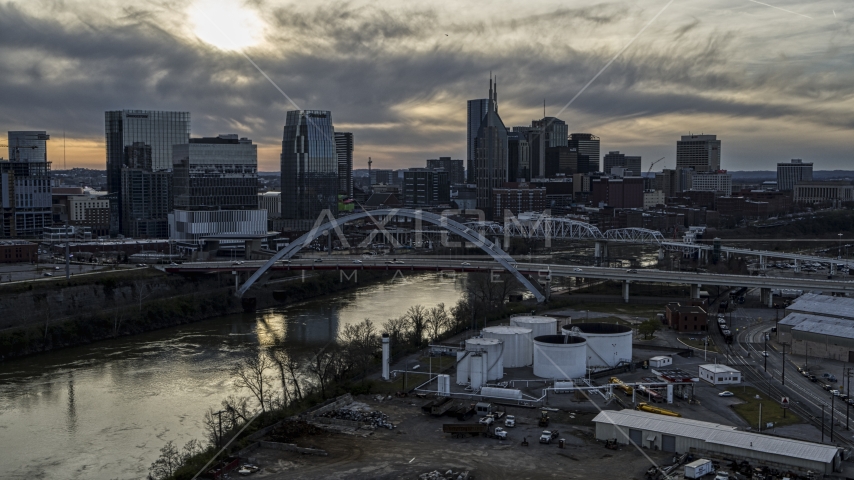 City skyline by bridges and Cumberland River at sunset, Downtown Nashville, Tennessee Aerial Stock Photo DXP002_119_0008 | Axiom Images