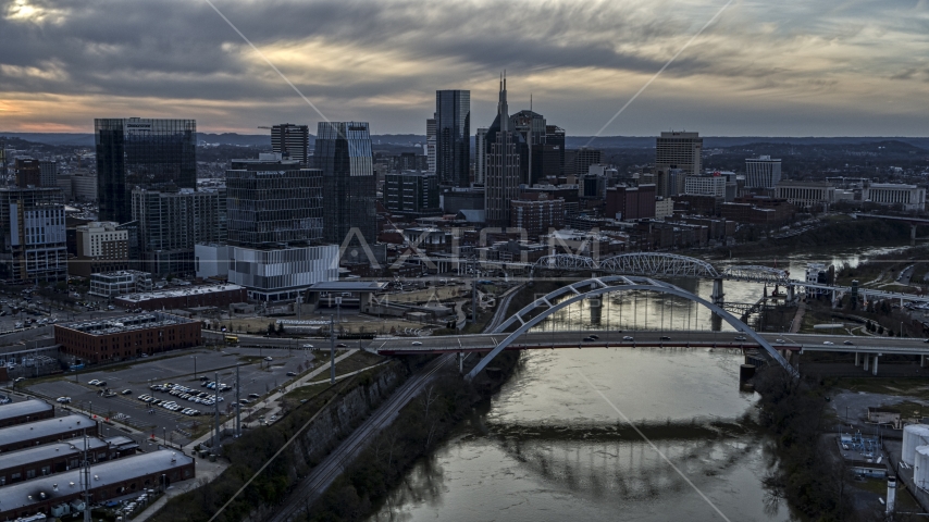 The skyline and a bridge over the Cumberland River at sunset, Downtown Nashville, Tennessee Aerial Stock Photo DXP002_119_0015 | Axiom Images