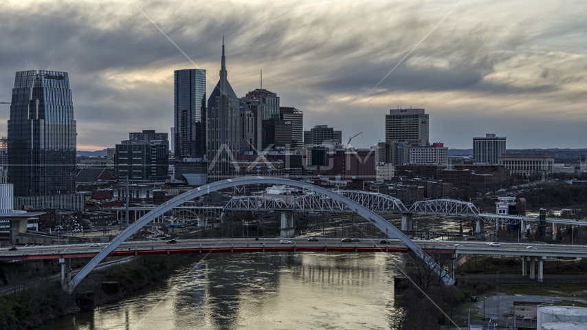 Riverfront skyline seen from a bridge and Cumberland River at sunset, Downtown Nashville, Tennessee Aerial Stock Photo DXP002_120_0003 | Axiom Images