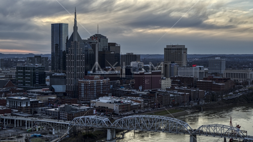 The riverfront skyline, and a bridge spanning the Cumberland River at sunset, Downtown Nashville, Tennessee Aerial Stock Photo DXP002_120_0005 | Axiom Images