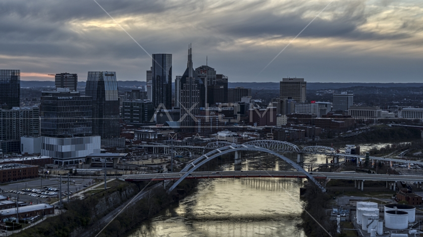A view of the riverfront skyline and bridges spanning the Cumberland River at sunset, Downtown Nashville, Tennessee Aerial Stock Photo DXP002_120_0008 | Axiom Images