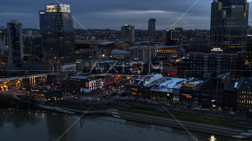 Riverfront buildings, cars on Broadway at twilight, Downtown Nashville, Tennessee Aerial Stock Photo DXP002_120_0013 | Axiom Images