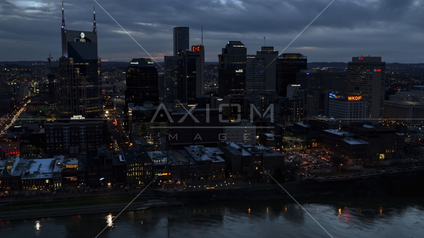A group of skyscrapers at twilight on the other side of the river, Downtown Nashville, Tennessee Aerial Stock Photo DXP002_120_0018 | Axiom Images