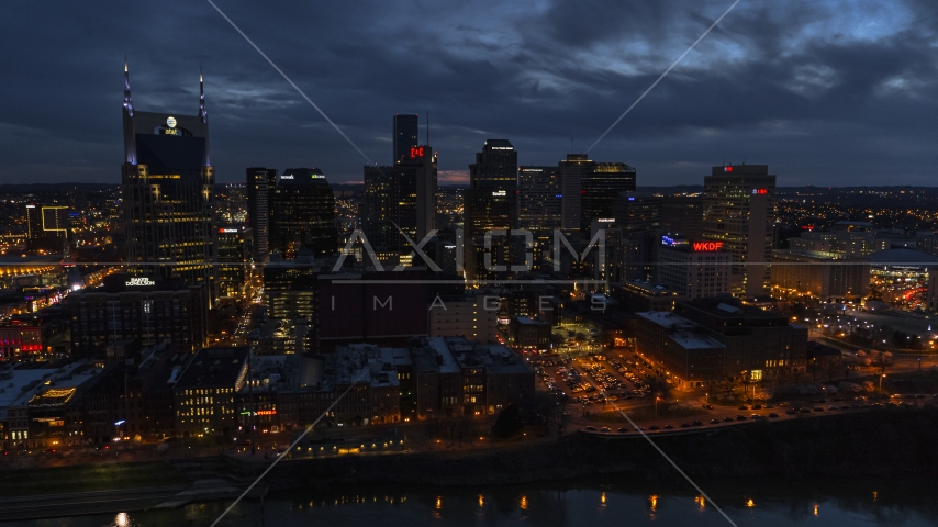 AT&T Building and the city's skyline at twilight, seen from Cumberland River, Downtown Nashville, Tennessee Aerial Stock Photo DXP002_121_0003 | Axiom Images